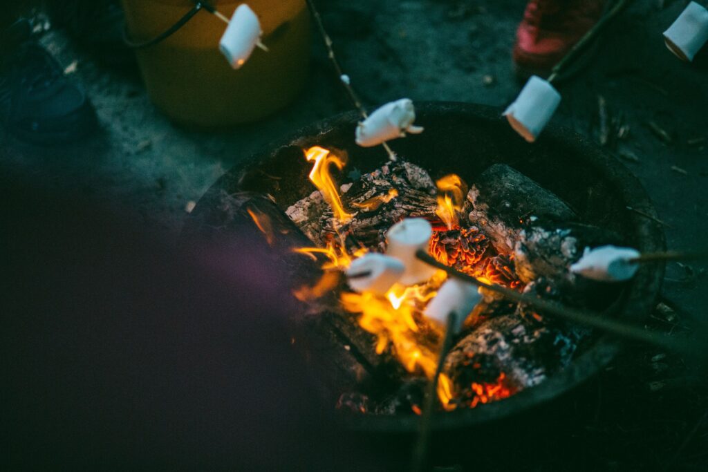 Marshmallows being roasted over a fire pit